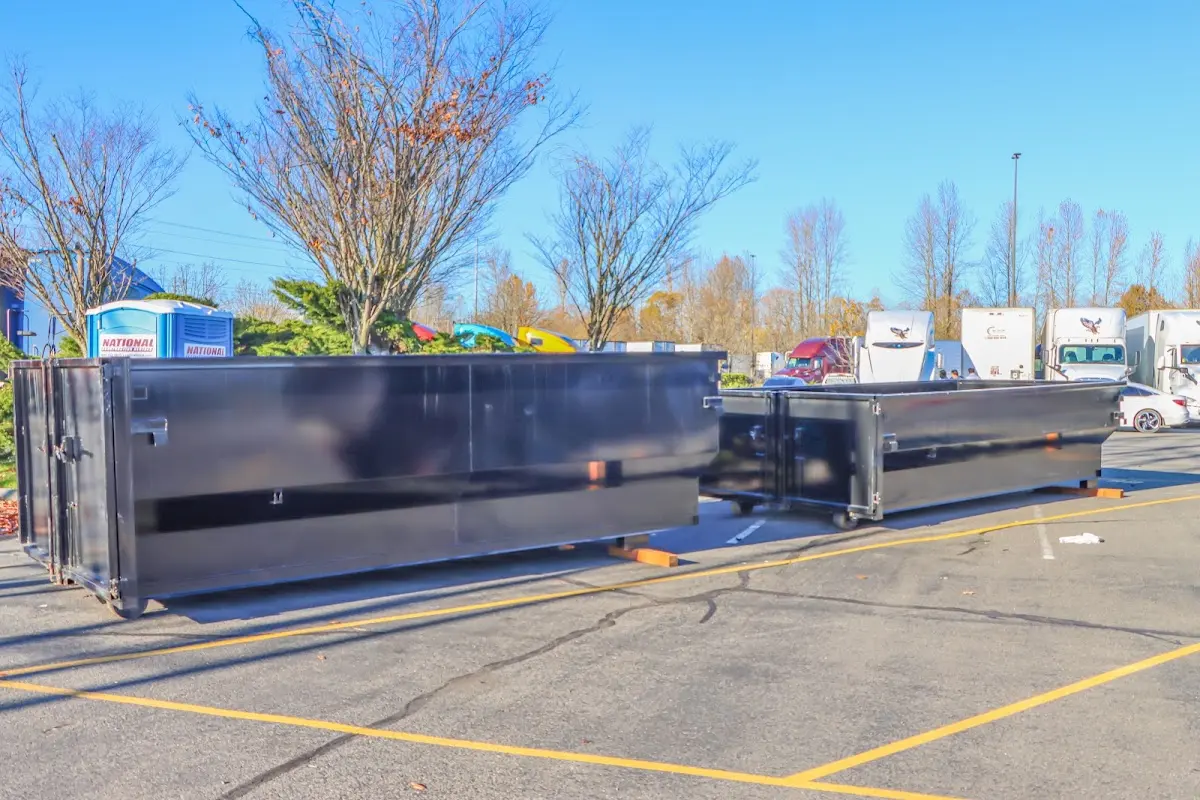 Professional dumpster rental service with roll-off container on residential driveway in Aspen Hill